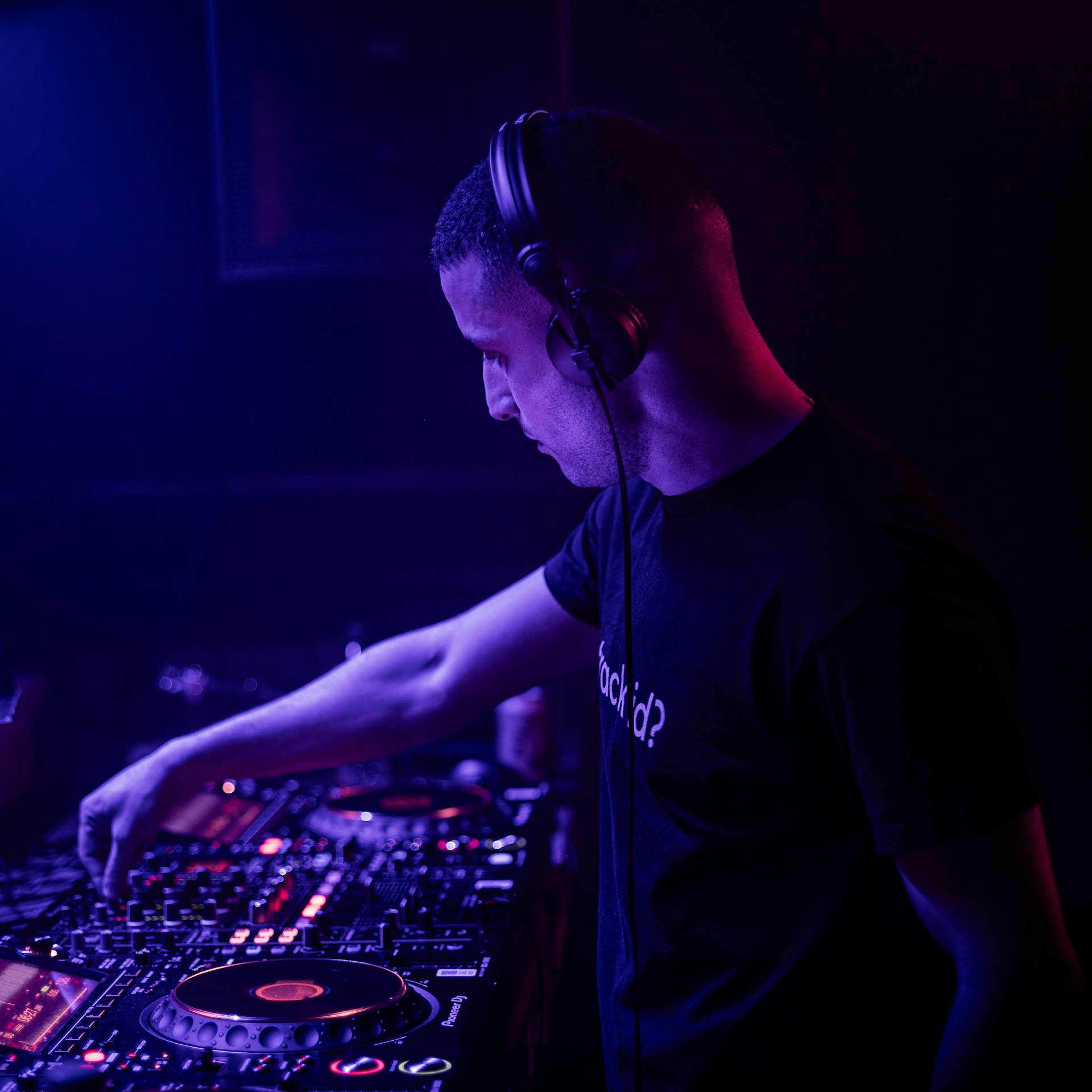 a dj mixing music in a dark room
